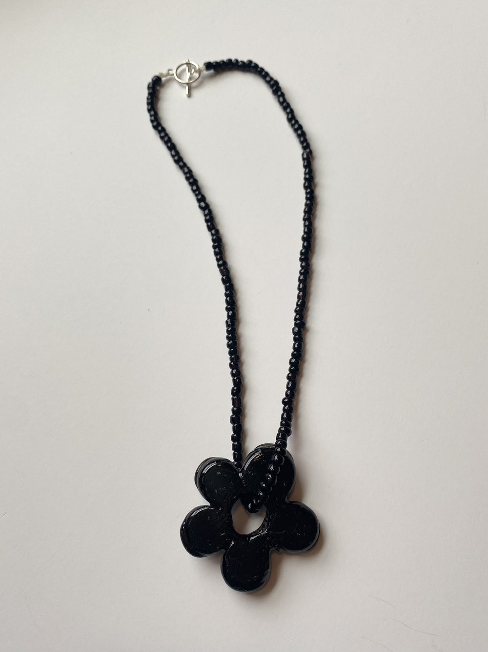 Black flower store pendant necklace